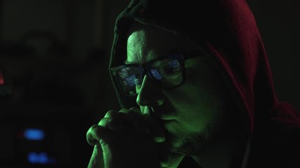 Hacker and running code on the computer screen