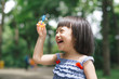 © makistock - Portrait of funny lovely little girl blowing soap bubbles