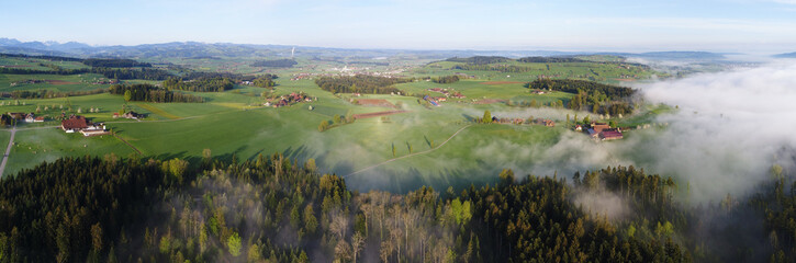 Wall Mural - Panorama aerial view of the hilly landscape in central Switzerland on a beautiful spring morning