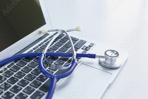 Cuadros en Lienzo Stethoscope lying on a laptop keyboard in a concept of online medicine or troubl
