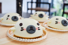Homemade White Chocolate Cheese Cake Dessert Decorated Look Like Cute Seal Face Animal Shape On Wooden Table Background For Party. Ideas Concept.