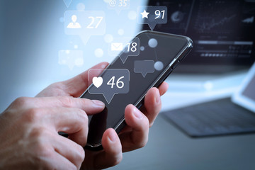 Poster - close up of businessman hand working with mobile phone and laptop and digital tablet computer in modern office