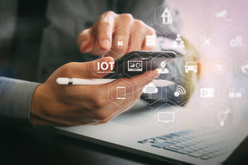 Poster - close up of businessman working with mobile phone and stylus pen and laptop computer on wooden desk in modern office