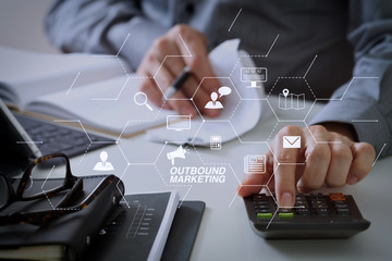 Poster - businessman hand working with finances about cost and calculator and latop with mobile phone on withe desk in modern office
