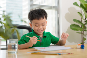 Hands of painting little boy and the table for creativity