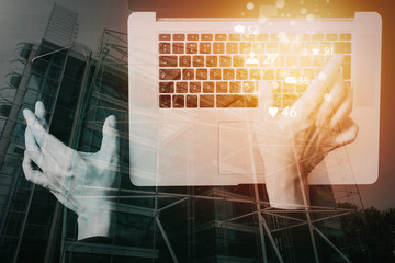 Poster - cyber security internet and networking concept.Businessman hand working with VR screen padlock icon mobile phone on laptop computer background with buildings exposure