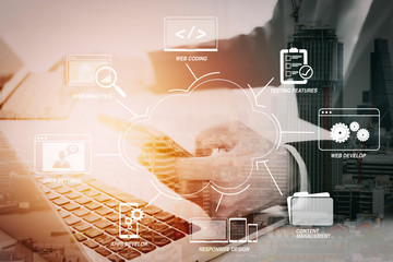 Hands of businessman using mobile phone in modern office with laptop and digital tablet computer with VR icon diagram