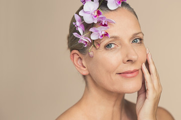 Wall Mural - beauty aged woman with pink orchids