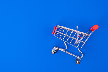 Shopping cart on blue background