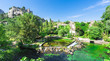 The river Sorgue in Fontaine de Vaucluse in the background the castle ruins from Philp Cabassole. Vaucluse, Provence, France, Europe
