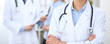 © rogerphoto - Female doctor standing straight in hospital. Closeup of stethoscope at practitioner breast. Medicine and health care concept