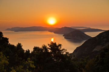 Aerial sunrise behind Alonisos island from the top of a hill in Skopelos, Greece