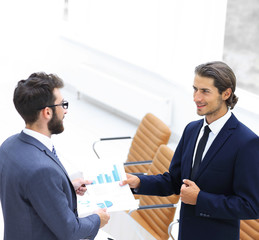 two businessmen talking in the office.