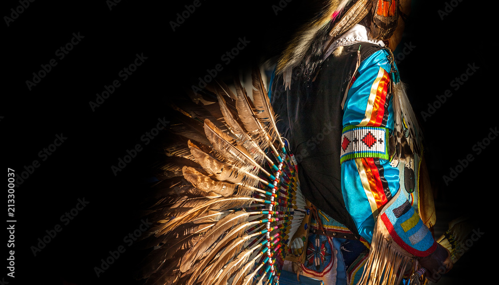 Native American Indian. Close up of colorful dressed native man isolated on black background. - obrazy, fototapety, plakaty 
