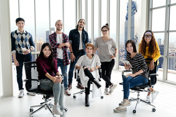 Wall Mural - Portrait of happy diverse creative business team group looking at camera and smiling. Multiethnic success designer start up team working together on creative project. Group shot partnership concept.