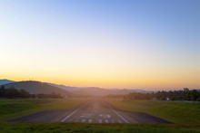 Airport Runway In The Evening Sunset Light.