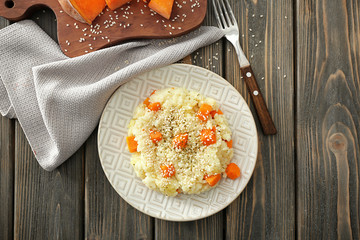 Sticker - Plate with delicious pumpkin risotto on wooden table