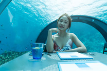 Asian Beautiful Woman Dinner On Undersea World.