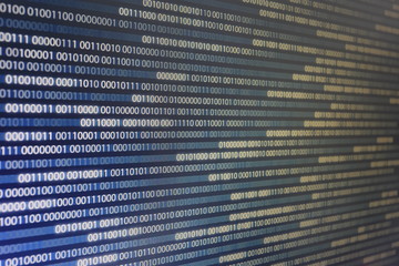 blocks of binary data. Blockchain concept. blue background with computer digital binary code bit number one and zero text. selective focus on the far end of the computer display out of focus in front.