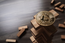 Bitcoin On The Wooden Building Blocks Tower. Concept For Bitcoin Risk Or Bitcoin Strategy