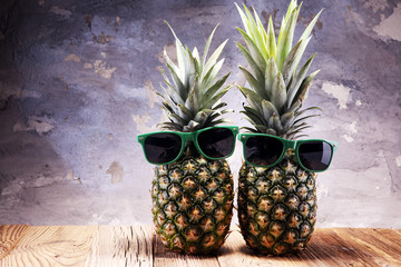 Ripe pineapples on rustic wooden table