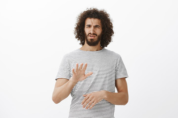 Wall Mural - What and awful idea, no. Portrait of displeased disgusted handsome male model with beard and afro hairstyle, shaking palm in stop or enough gesture, frowning from dislike, rejecting offer