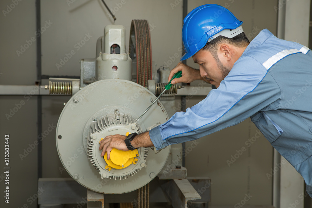 Maintenance engineer repairing lift Motor for elevators Stock Photo ...