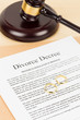 © wirojsid - Wooden judge gavel, golden rings, and divorce decree; document is mock-up