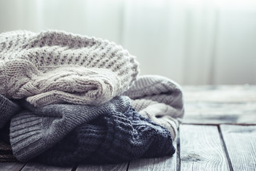 Wall Mural - Knitted sweater on a wooden background