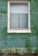 Green Painted Brick Wall With White Window