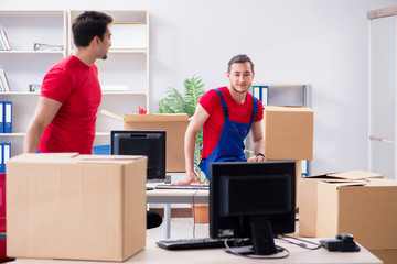 Two contractor employees moving personal belongings