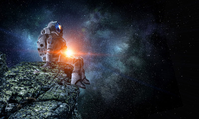 Wall Mural - spaceman on rock edge. mixed media