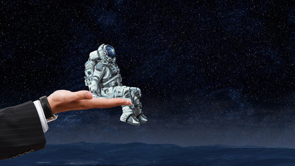 Wall Mural - spaceman on finger. mixed media