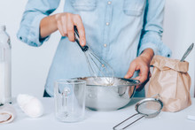 Woman's Hands Holding Whisk And Metal Bowl