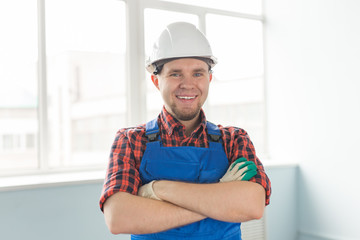 Closeup portrait of happy caucasian male builder wearing white helmet.