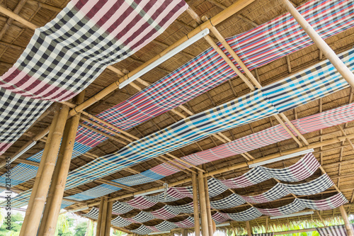 Fotografía Traditional loincloth (sarong) in Thailand decorate on bamboo beam in countryside