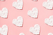 Hearts pattern from cream in pink background. Skin care