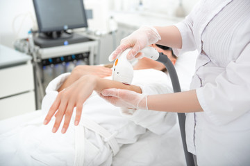 close up female hand in glove making correction for patient with special appliance