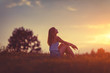 © astrosystem - Girl enjoying in the meadow at golden sunset time.
