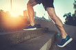 © Yakobchuk Olena - Sport hard. Close up of male feet climbing stairs outside. Well shaped man is jogging at dawn