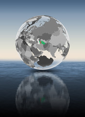 Turkmenistan on translucent globe above water
