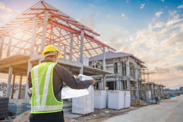 professional engineer architect worker with protective helmet and blueprints paper at house building