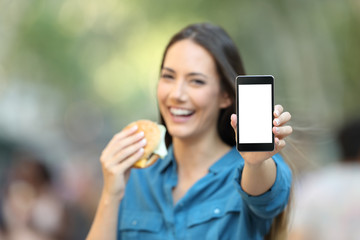 Poster - Woman holding a burger showing a phone screen