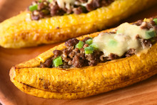 Baked Ripe Plantain Stuffed With Mincemeat, Olive, Green Bell Pepper, Onion, Traditional Dish In Central America Called Canoa De Platano (Plantain Canoe) (Selective Focus In The Middle Of The Image)