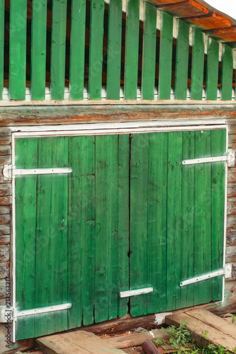 Vivid Wooden Gates In Shed Painted Of Green Paint With White Iron