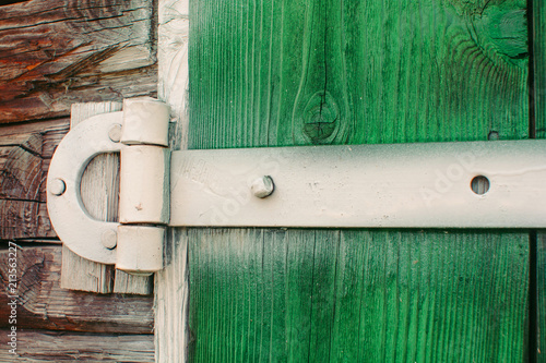 Painted White Iron Hinges On Green Wooden Gates Of Shed Close Up