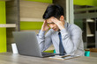 © NopponPAT - Business man feeling stressed with laptop computer. Young Asian male headache with project problem. people working with digital technology concept.