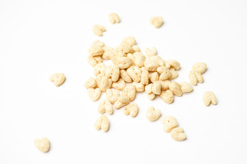 Piles of pale heart shaped children's puffed cereal snack