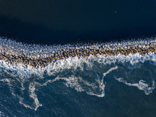  Aerial View Of Ocean Waves Crashing On Jetty Rocks