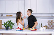 © mikitiger - cute young woman and man in white kitchen near table in house